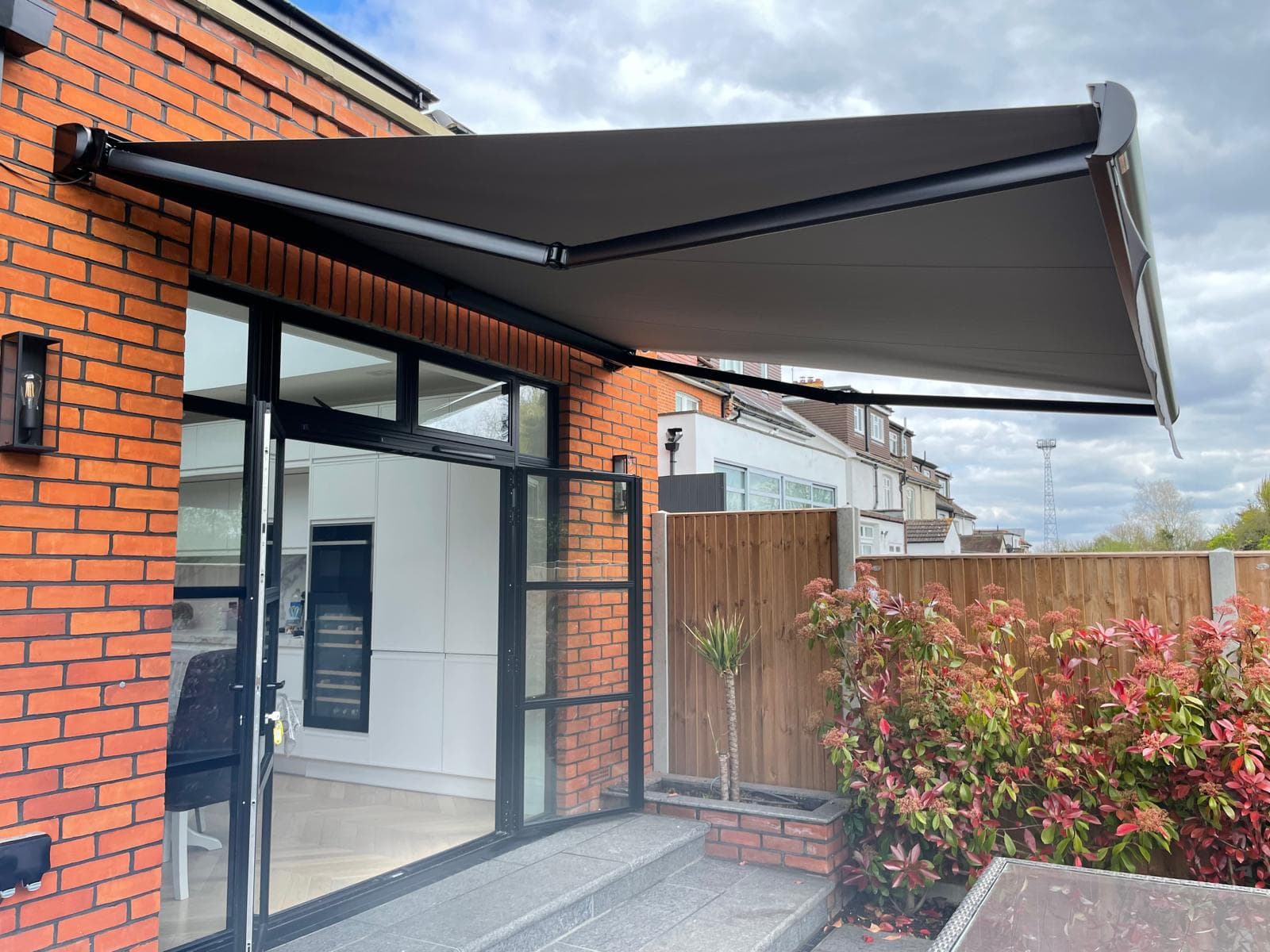 Motorised awnings for outdoor spaces
