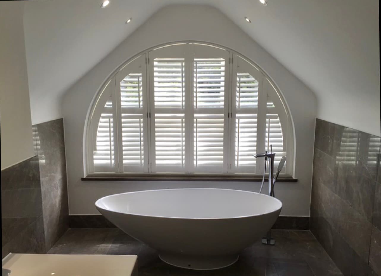 Plantation shutters for curved top windows