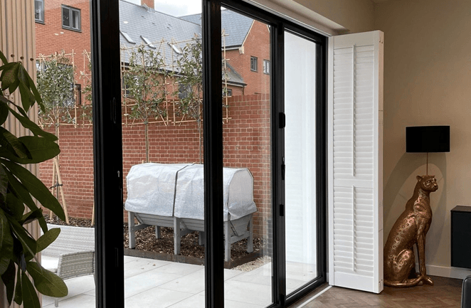 Bi-fold tracked shutters