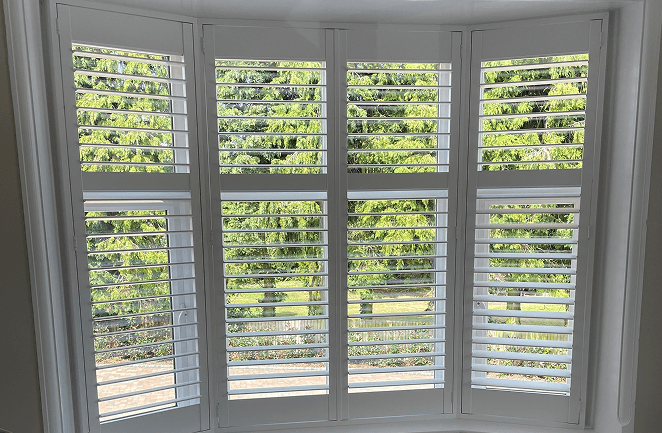 Custom wooden shutters for angled bay windows